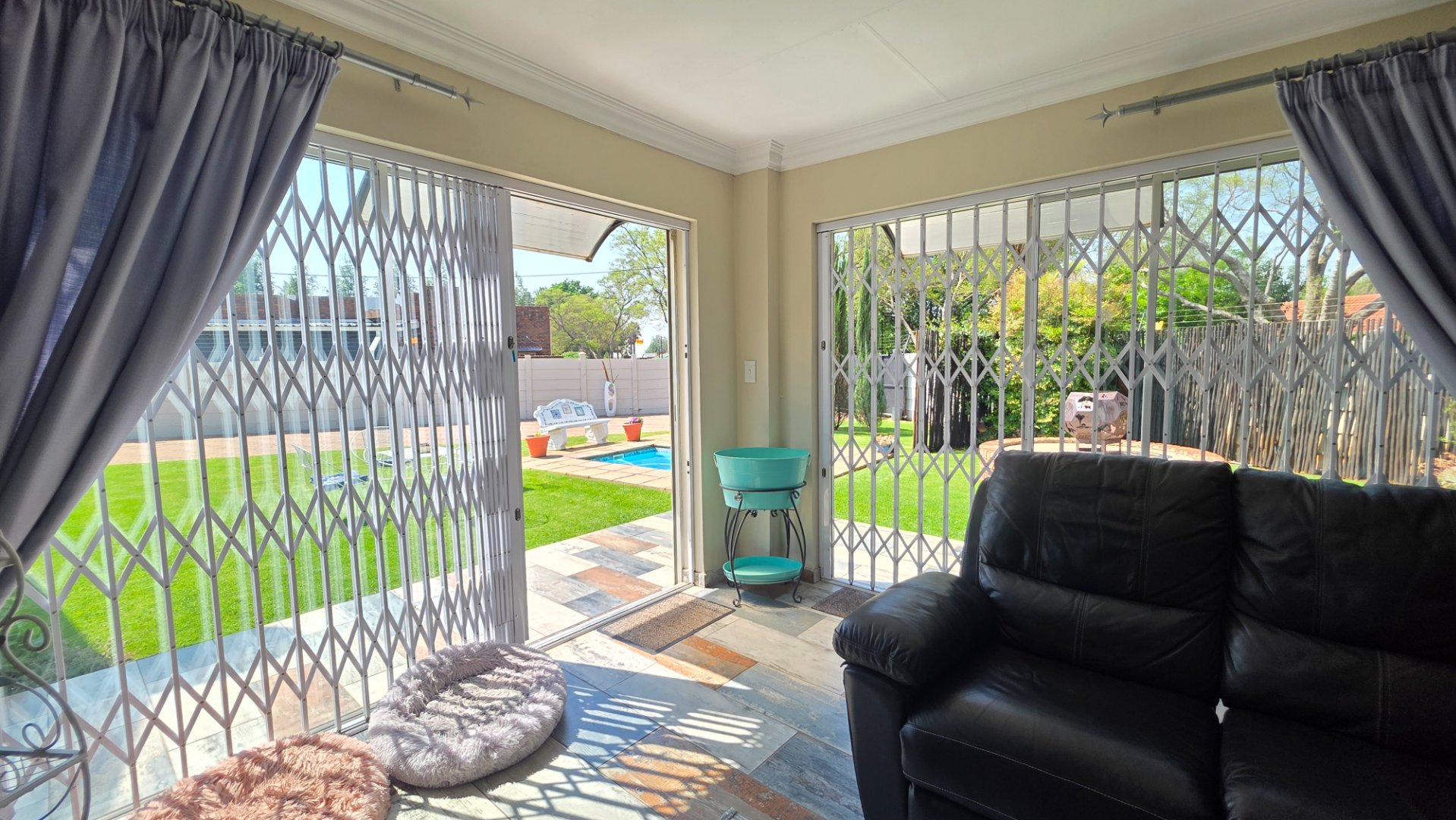 ENTERTAINMENT AREA WITH DOORS TO POOL