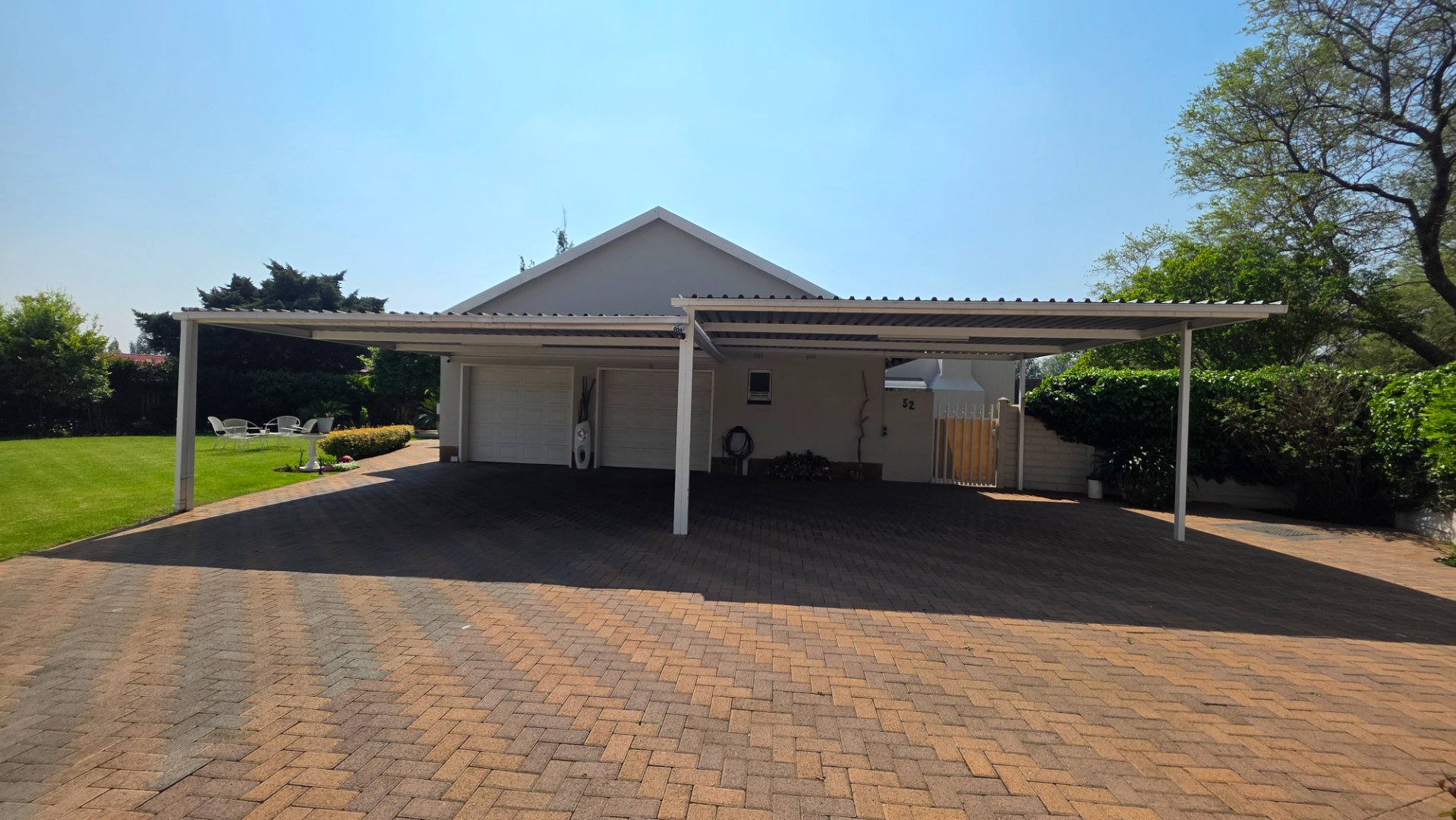 FRONT ENTRANCE WITH CARPORTS AND DOUBLE GARAGES
