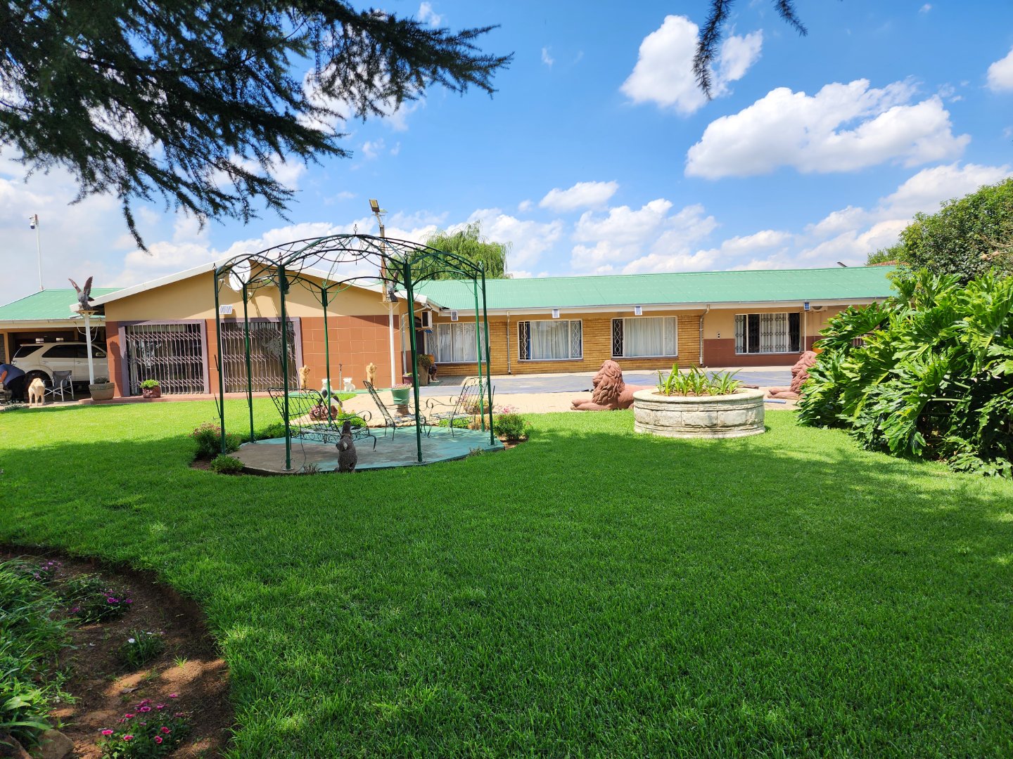 VIEW OF PROPERTY WITH POOL AND GARAGES