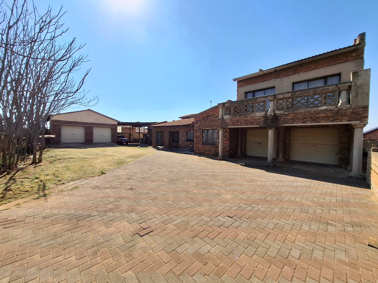 Family home with vast yard and multiple outbuildings